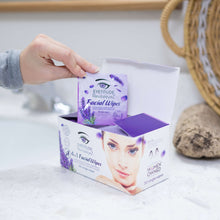 Load image into Gallery viewer, Hand reaching for RevitaleyeZ 4in1 Facial Wipes packet from a box on a bathroom counter.